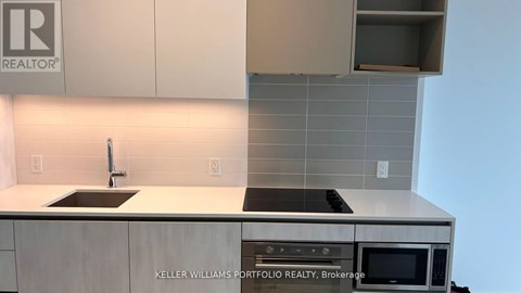A kitchen with a stove top oven and a microwave.