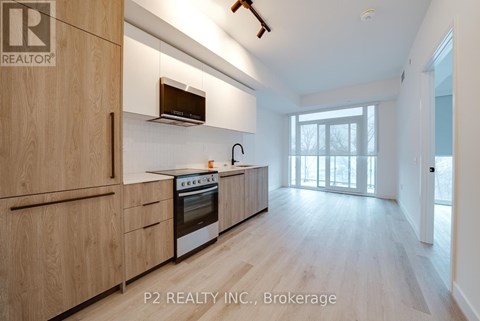 A modern kitchen with wooden cabinets and a stainless steel oven.