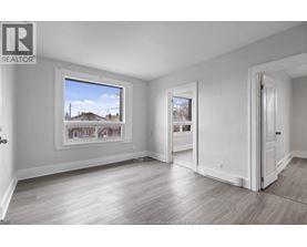A realtor's office with a large window showing a residential area.