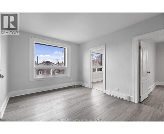 A realtor's office with a large window showing a residential area.