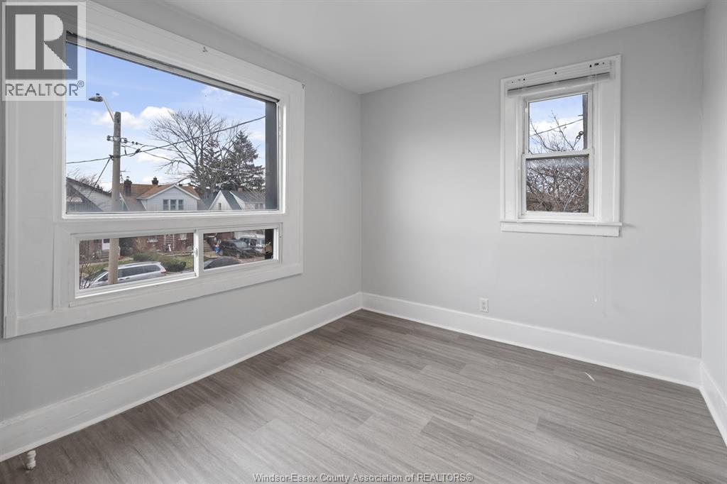 A room with a large window and a smaller window on the wall.