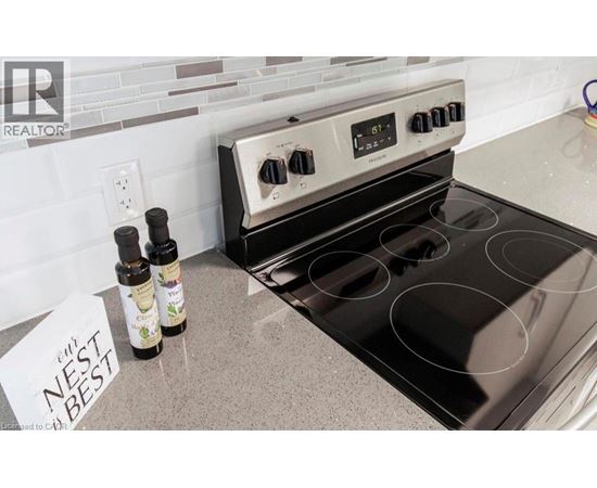 A stove top oven with a note that says nest best on the counter.