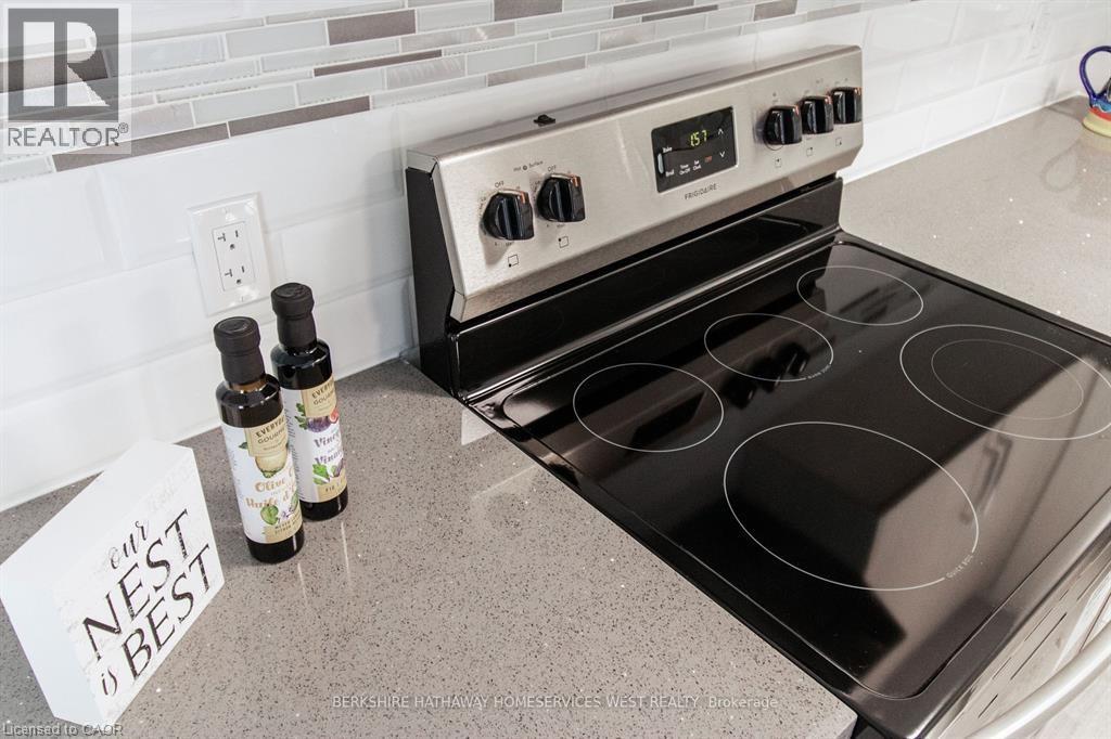 A stove top oven with a note that says nest best on the counter.