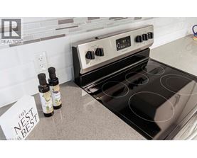 A stove top oven with a note that says nest best on the counter.