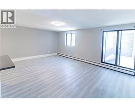 A spacious room with a sliding glass door and a window.