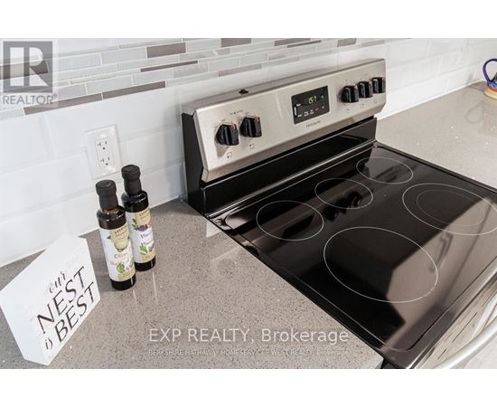 A stove top oven with a note that says nest best on the counter.