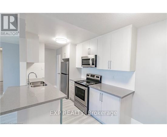 A kitchen with white cabinets and stainless steel appliances.