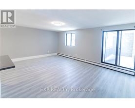 A room with EXP Realty Brokerage logo on the wall.
