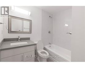 A bathroom with a toilet, sink, and bathtub.