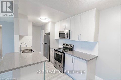 A kitchen with white cabinets and stainless steel appliances.