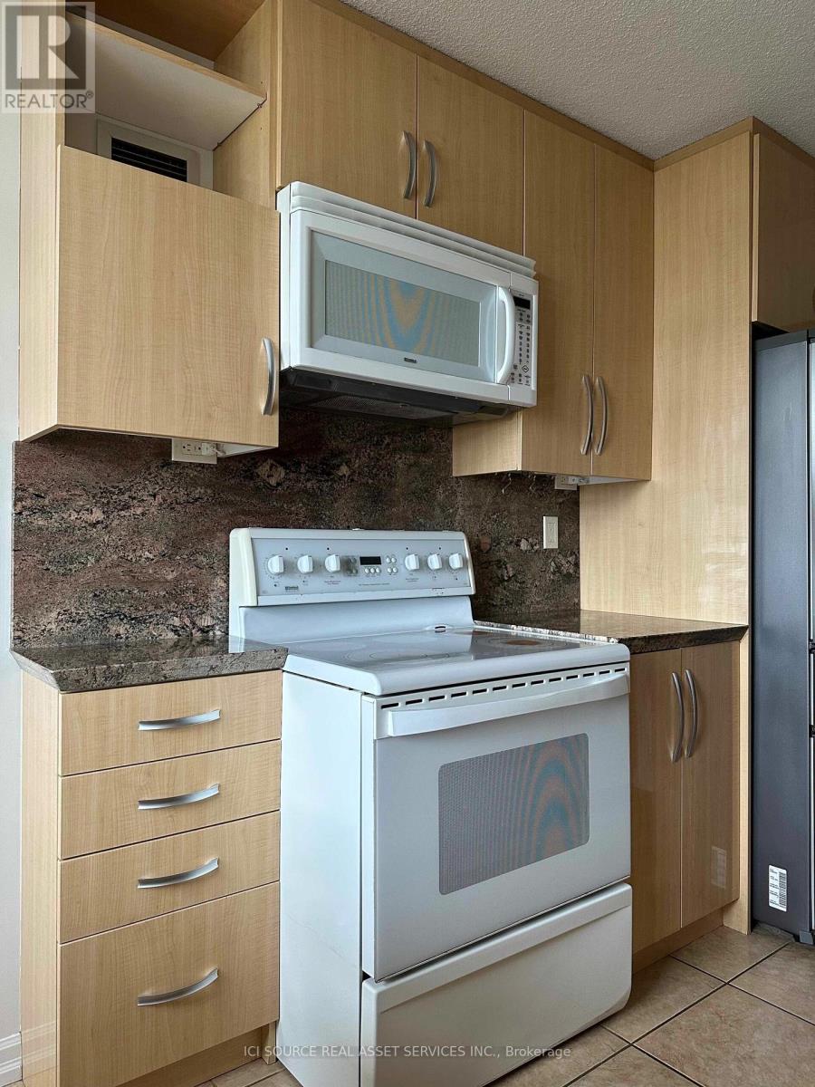 A kitchen with a stove, oven, and microwave.
