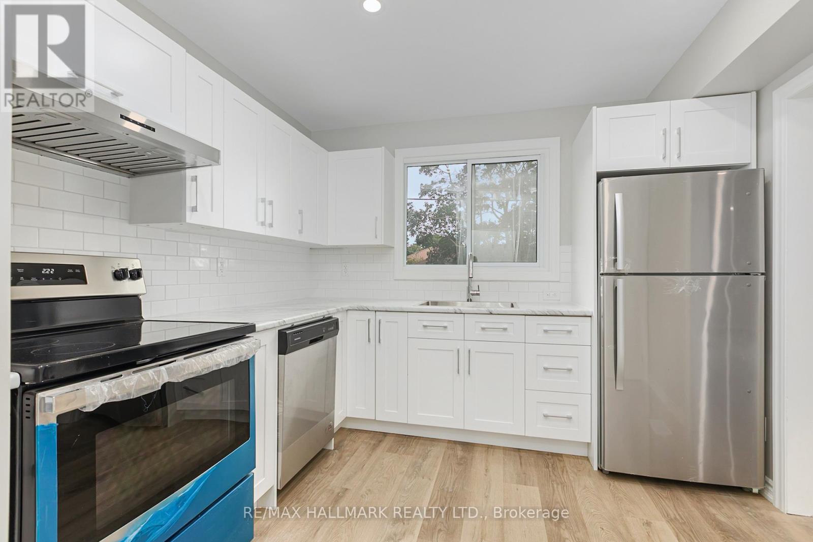 A kitchen with white cabinets and a blue stove top oven.