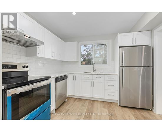 A kitchen with white cabinets and a blue stove top oven.