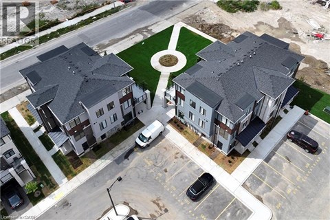 A bird's eye view of a residential area with houses and cars.