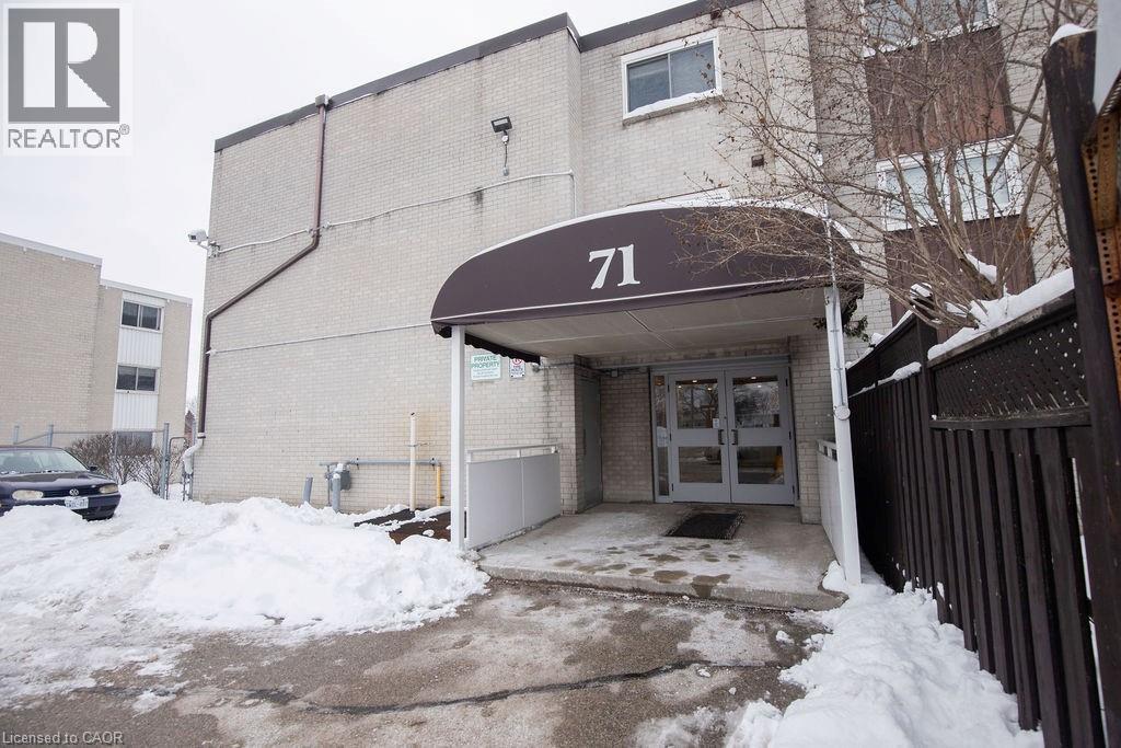 A building with the number 71 on it is surrounded by snow.