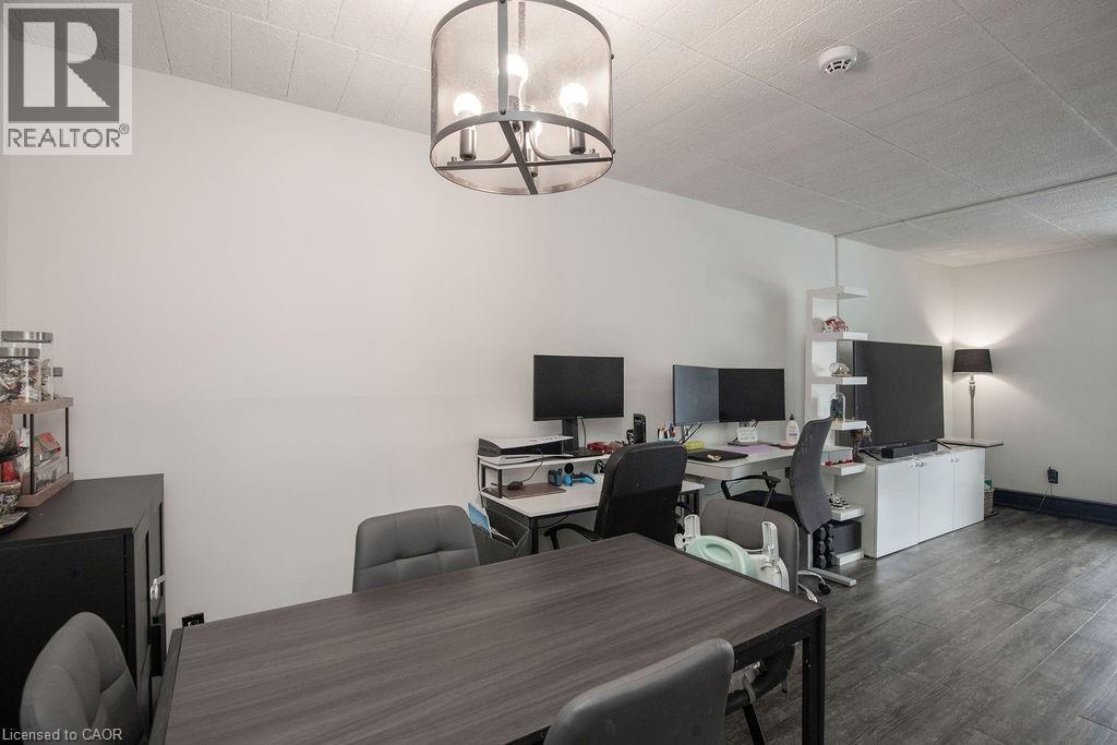 A conference room with a table, chairs, and a television.