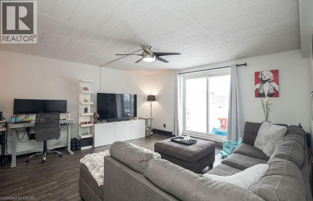 A living room with a grey couch and a television.