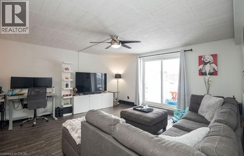A living room with a grey couch and a television.