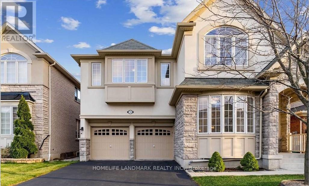 A large, two-story house with a garage is for sale.