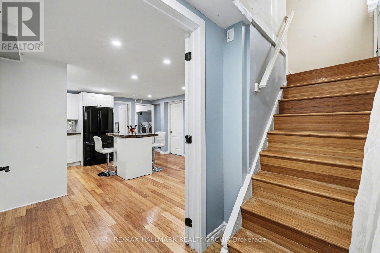 A staircase with wooden steps and a white railing.