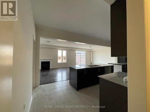 A spacious kitchen with black cabinets and a large island.