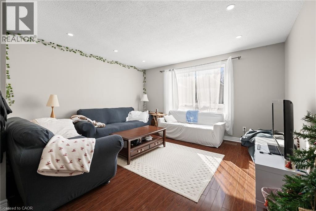 A living room with a grey couch and a white sofa.