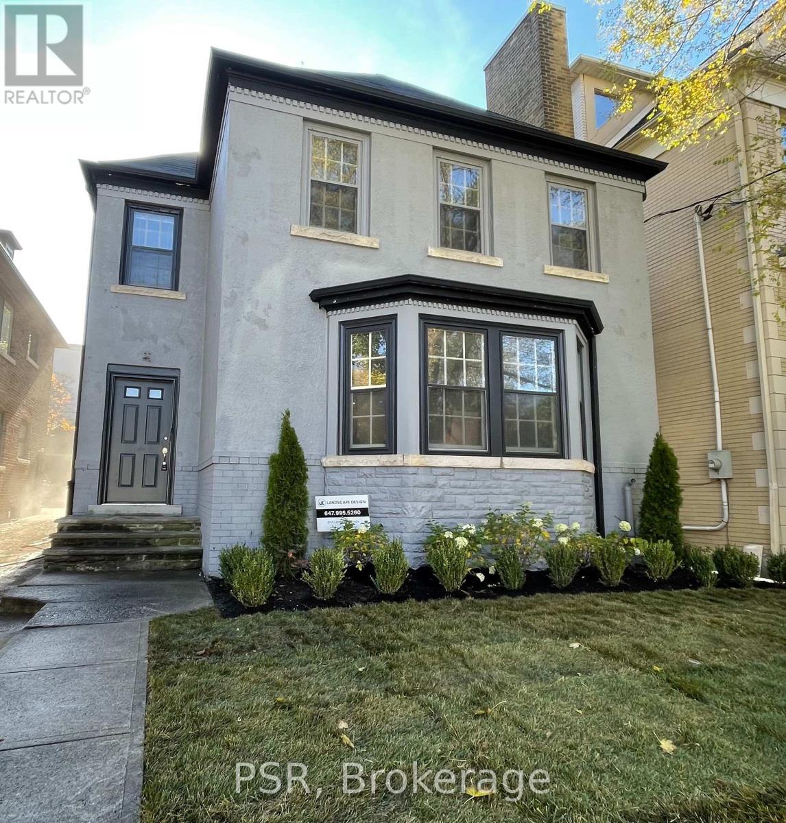A grey house with a sign that says PSR, Brookage in front of it.