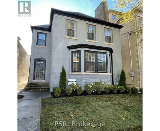 A grey house with a sign that says PSR, Brookage in front of it.
