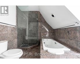 A bathroom with a large mirror and a window.