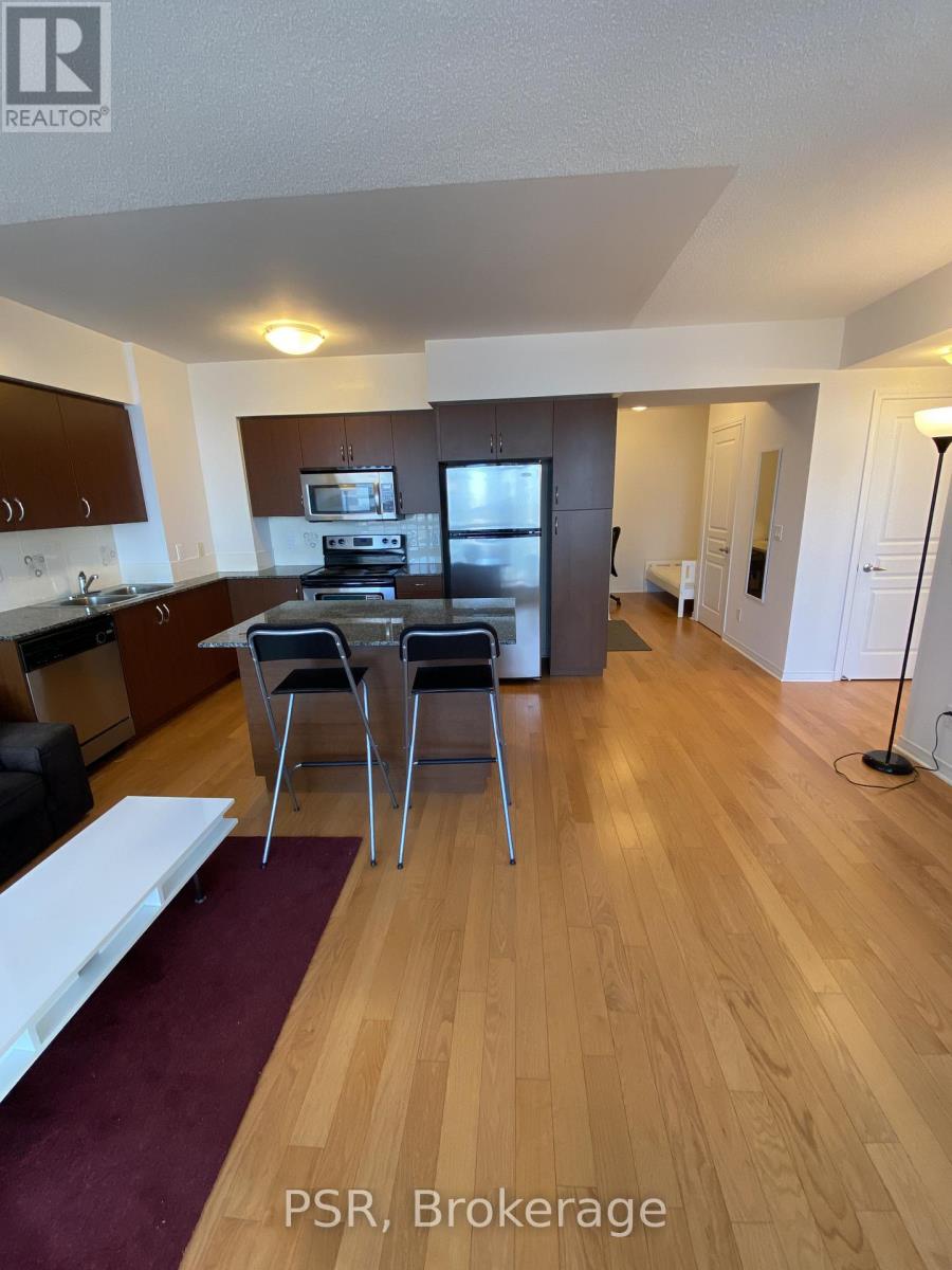 A kitchen with wooden floors and a dining table with chairs.