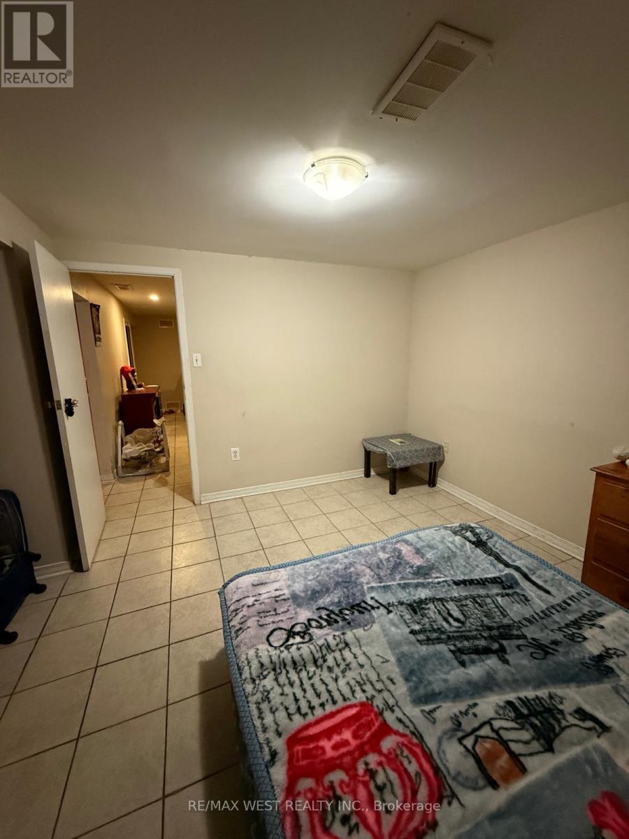 A bedroom with a bed, a chair, and a small table.