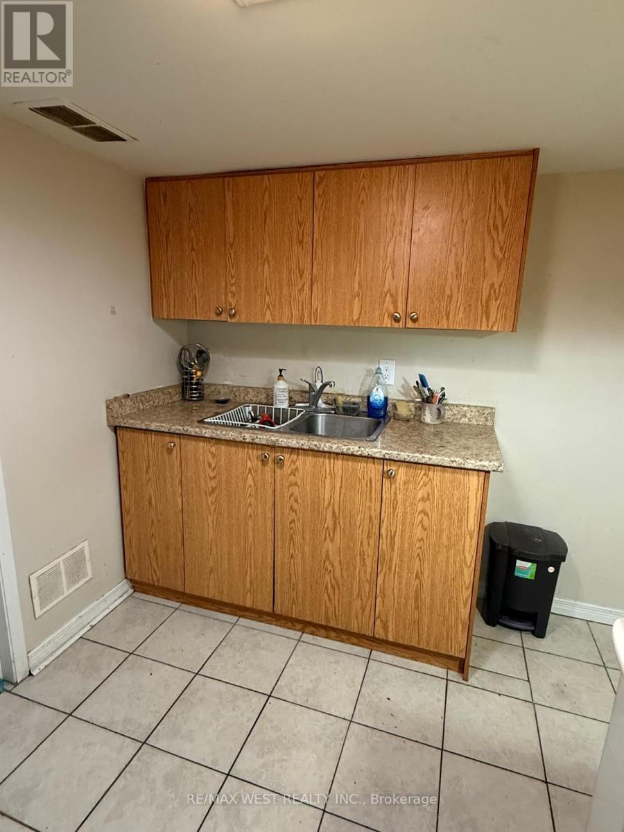 A kitchen with wooden cabinets and a granite countertop.