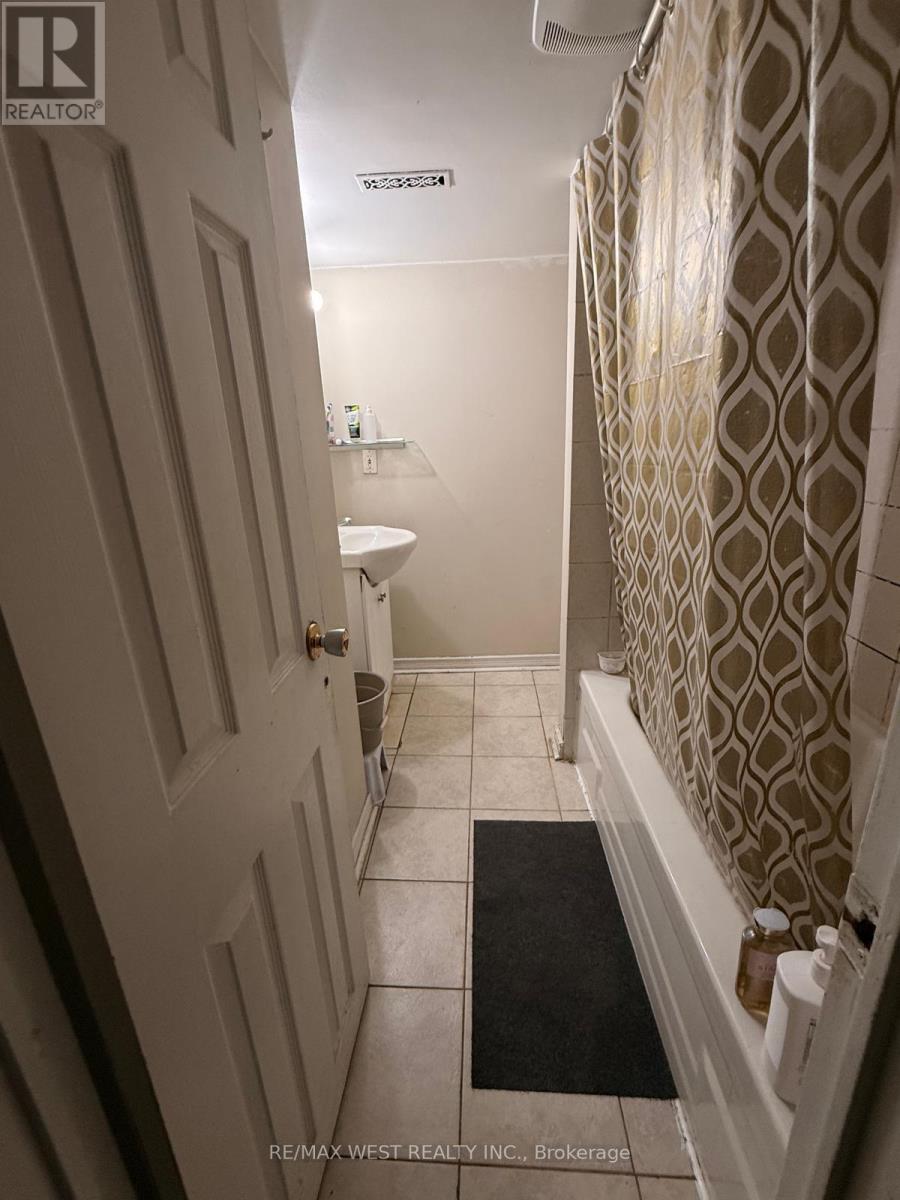 A bathroom with a toilet, sink, and shower curtain.