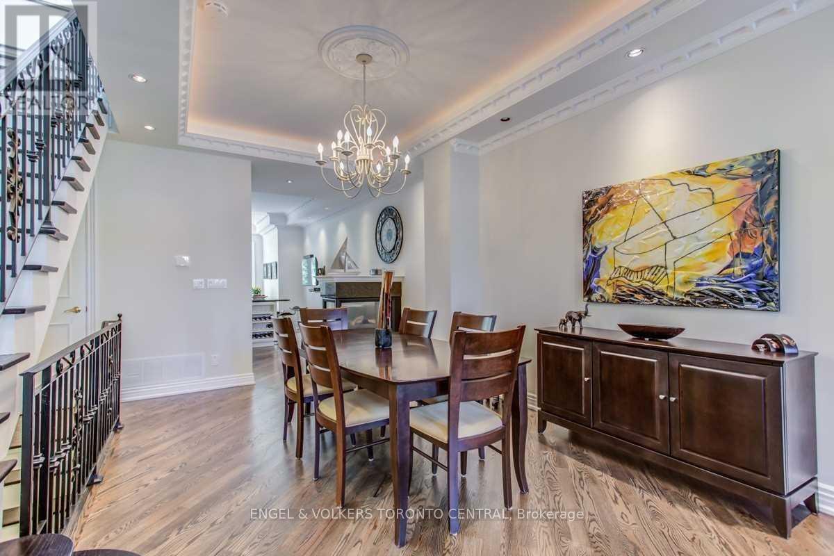 A dining room with a wooden table and chairs.