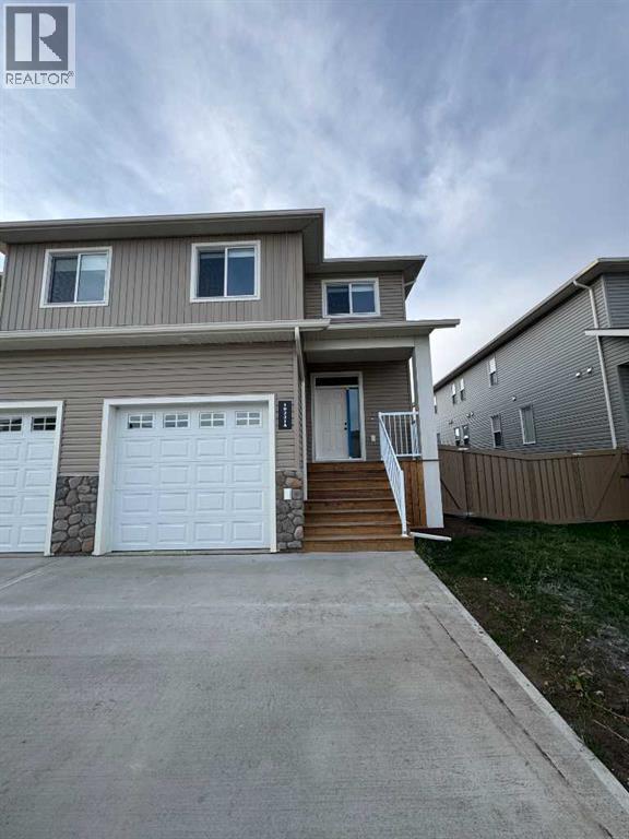 A two-story house with a garage is for sale.