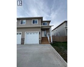 A two-story house with a garage is for sale.