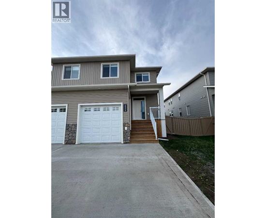 A two-story house with a garage is for sale.
