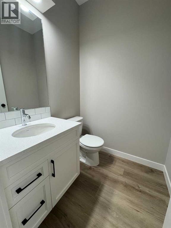 A bathroom with a white sink and toilet.