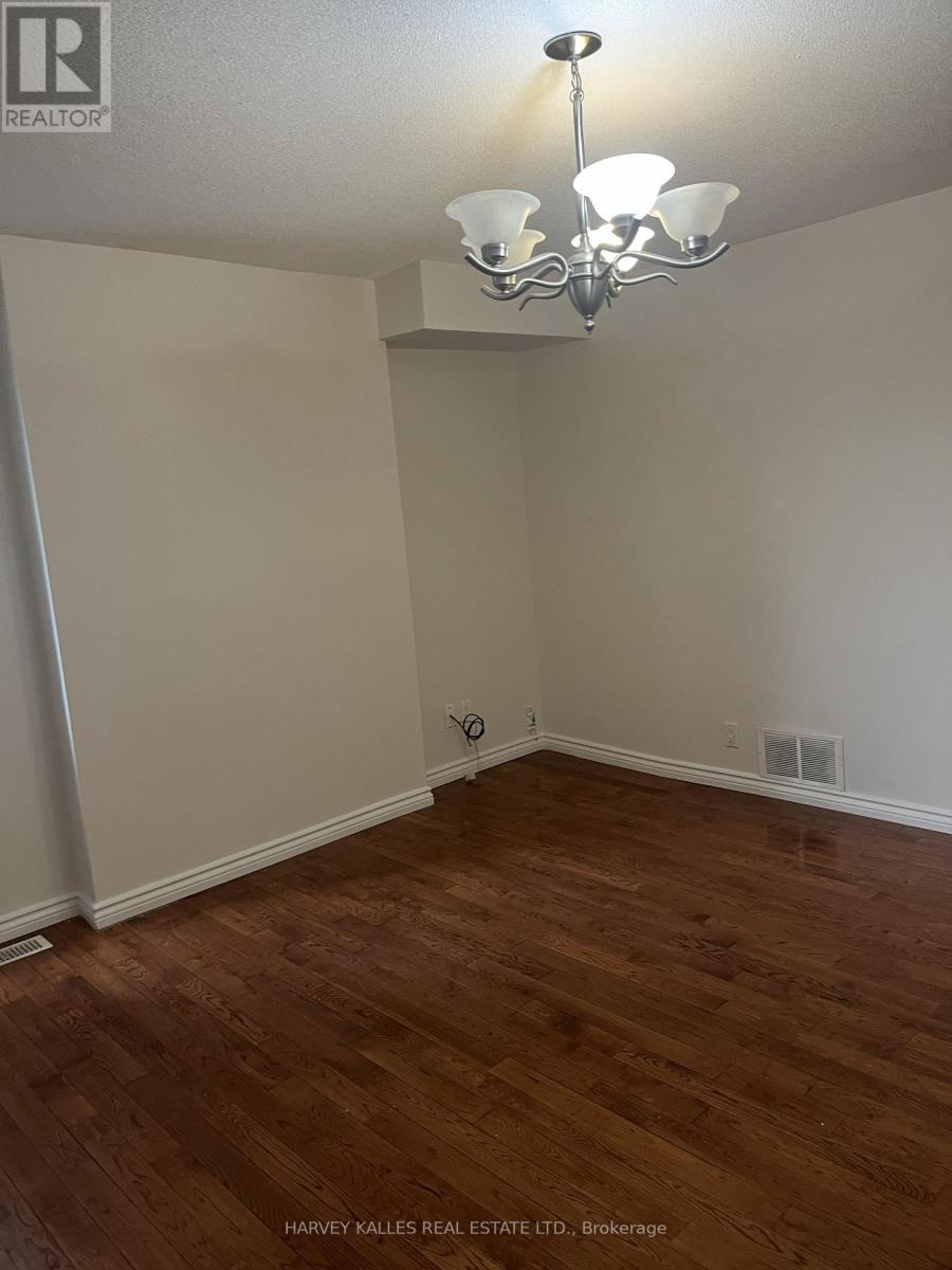 A room with wooden floors and a chandelier.