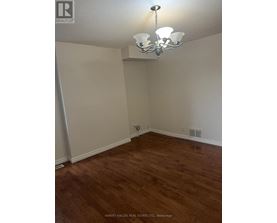 A room with wooden floors and a chandelier.
