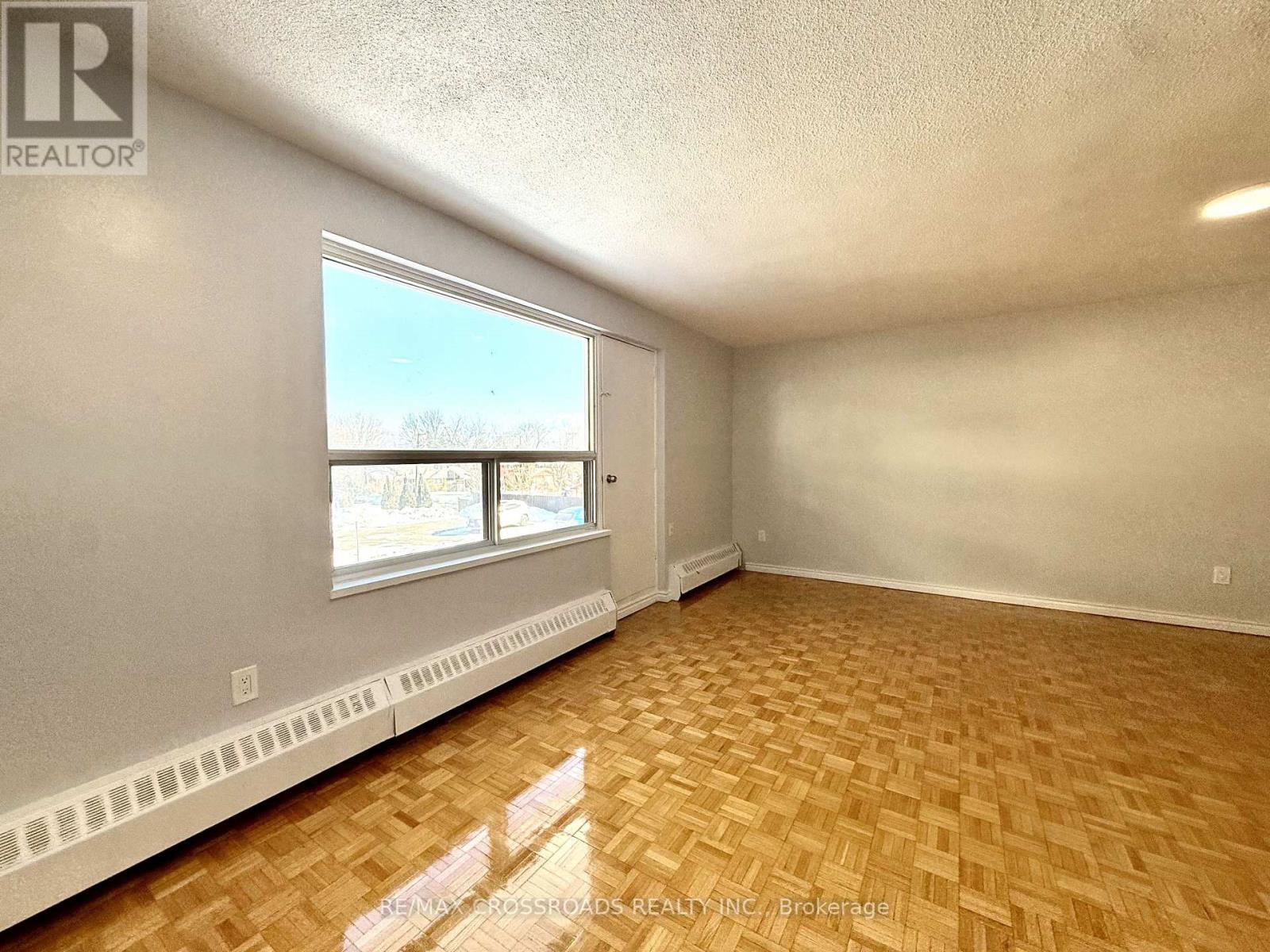 A room with a window and a radiator on the wall.