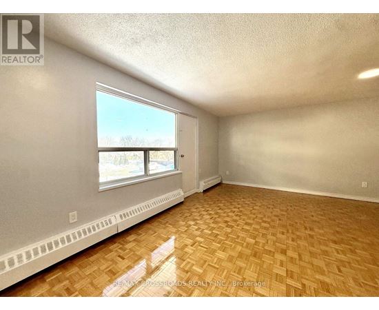 A room with a window and a radiator on the wall.