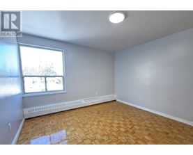 A room with a window and a radiator on the wall.