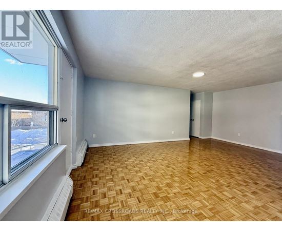 A room with a window and a radiator on the wall.