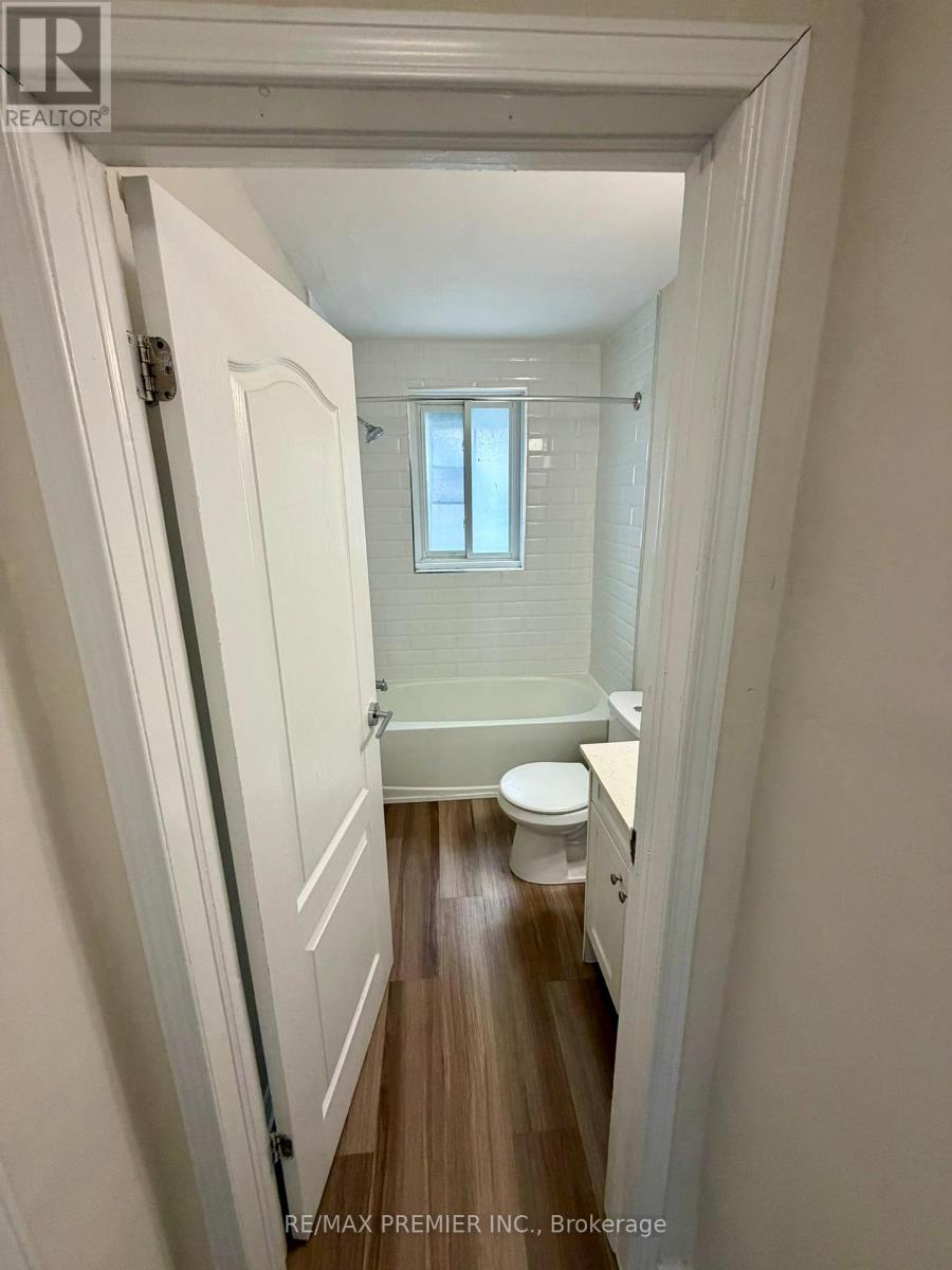 A white bathroom with a toilet, sink and bathtub.
