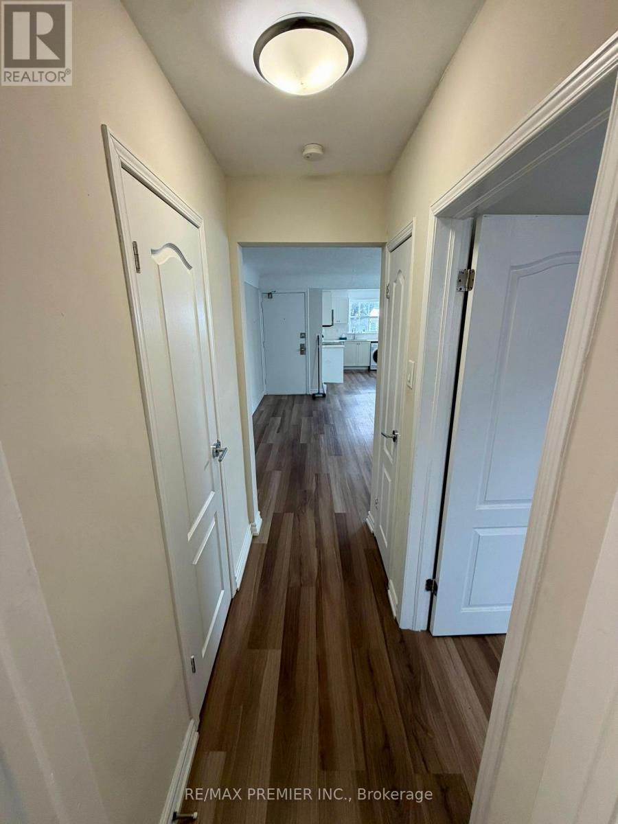 A hallway with white doors and wooden floors.