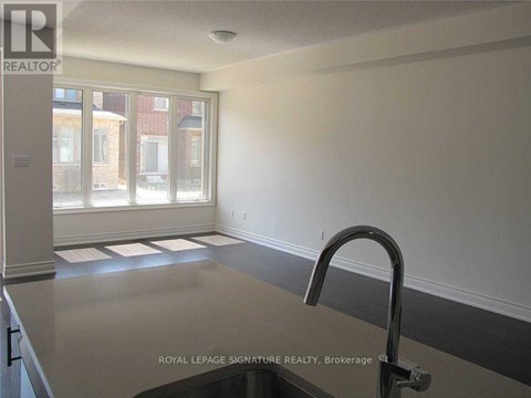 A kitchen with a sink and a window.