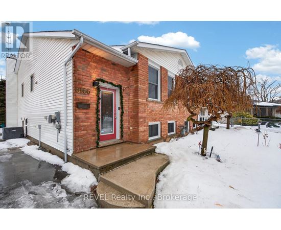 A house with a red door and a snow-covered ground.