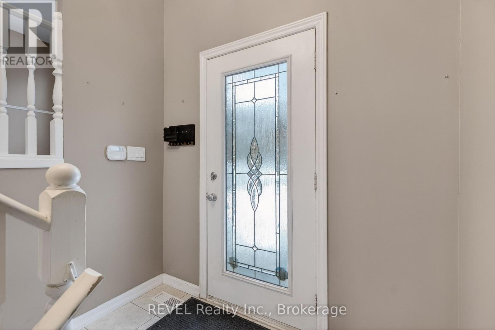 A white door with a glass panel and a diamond pattern in the middle.