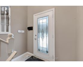 A white door with a glass panel and a diamond pattern in the middle.